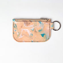 Load image into Gallery viewer, Back view of leather key chain zipper wallet with one zipper pocket and a shiny nickel key ring attached. No back pocket. Leather is a light natural color painted with water colors: brown, turquoise and and pearlescent white dyes. Dark brown thread.
