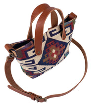 Load image into Gallery viewer, Overhead view of women's southwestern mini tote handbag. Chestnut brown leather handles with a removable, buckle adjustable strap. Antique brass hardware.