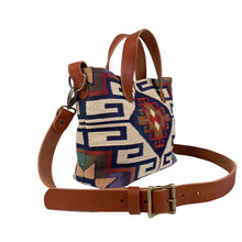 Load image into Gallery viewer, Side view of women's southwestern mini tote handbag. Chestnut brown leather handles with a removable, buckle adjustable strap. Antique brass hardware.